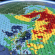 IBM interactive visualization showing evolving temperature and wind directions over China.